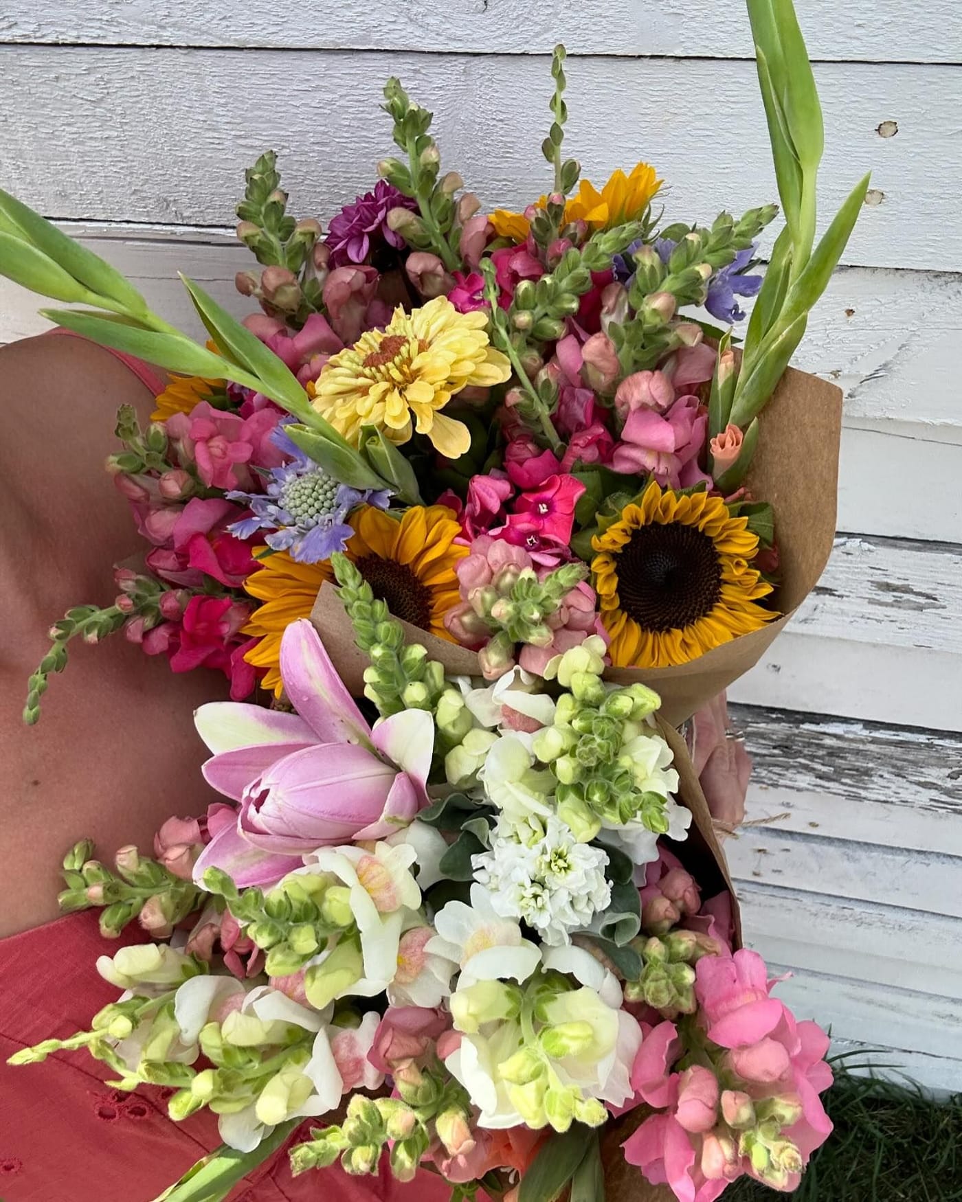 A handmade bouquet of peach and pink dahlias